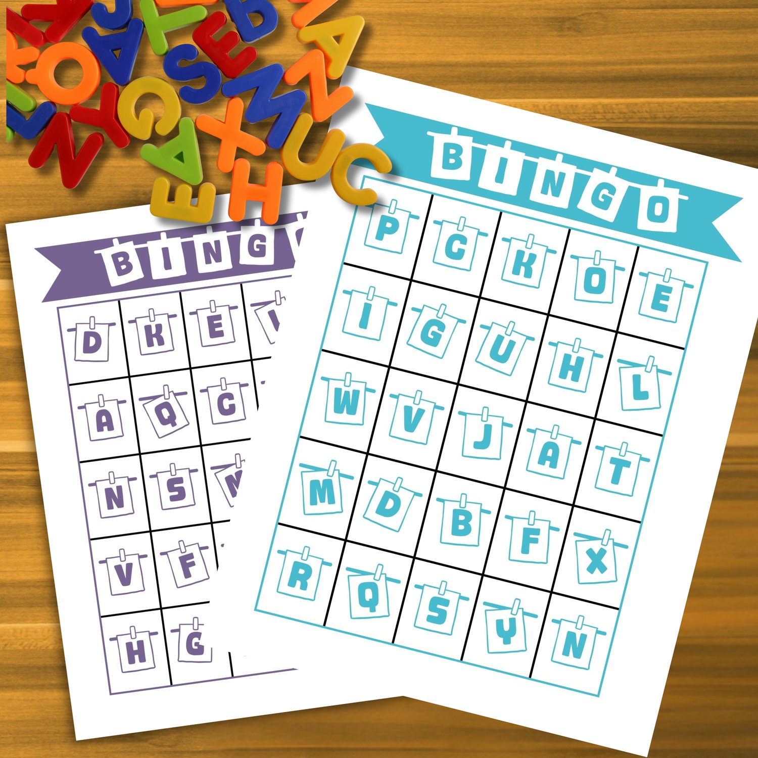 Colorful alphabet bingo cards in purple and teal featuring random uppercase letters on a wooden surface with magnetic letters. Fun and educational printable alphabet bingo cards for kids.