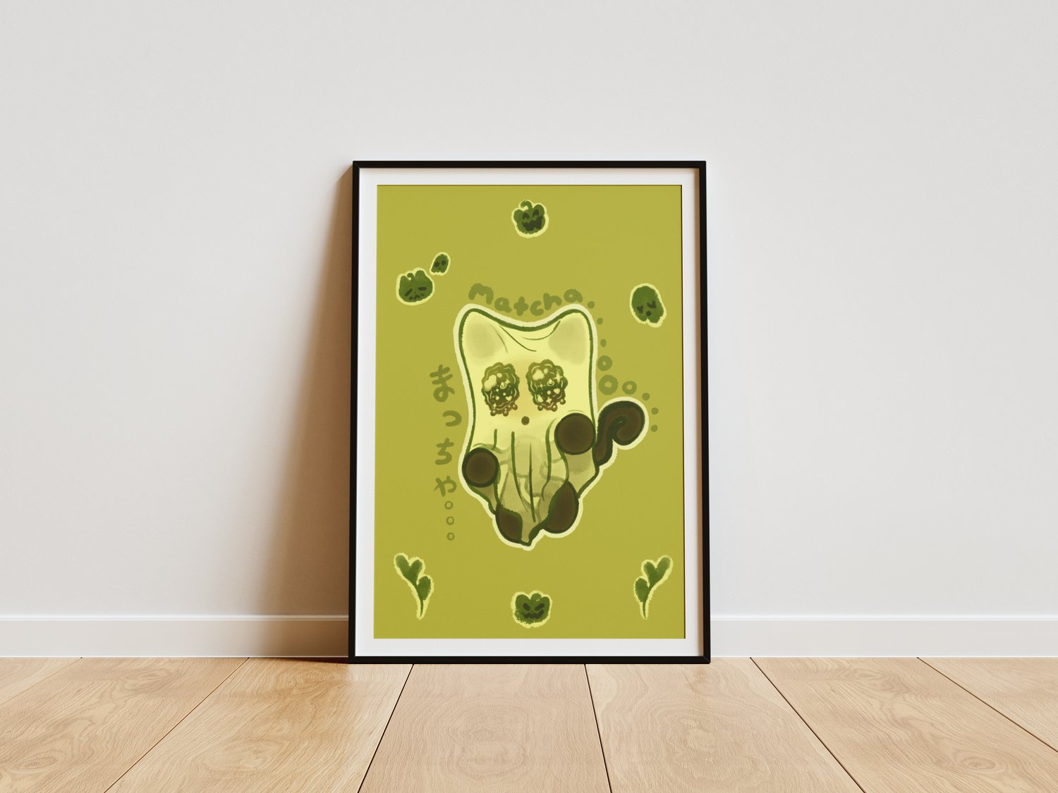 A wall art piece of a dark brown/black cat with a white bedsheet over its head, giving it the appearance of a sheet ghost. There are cartoonish, green cat pumpkins, ghosts and matcha tea leaves surrounding the cat. Decorative text in the illustration read