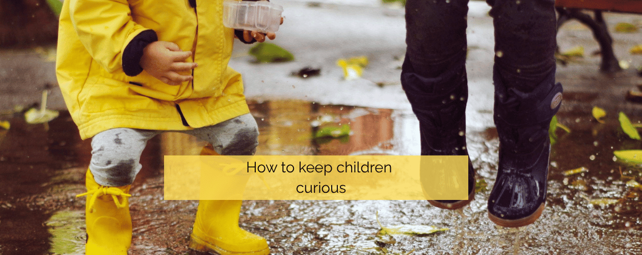 How to keep children curious - two children jumping in rain puddles