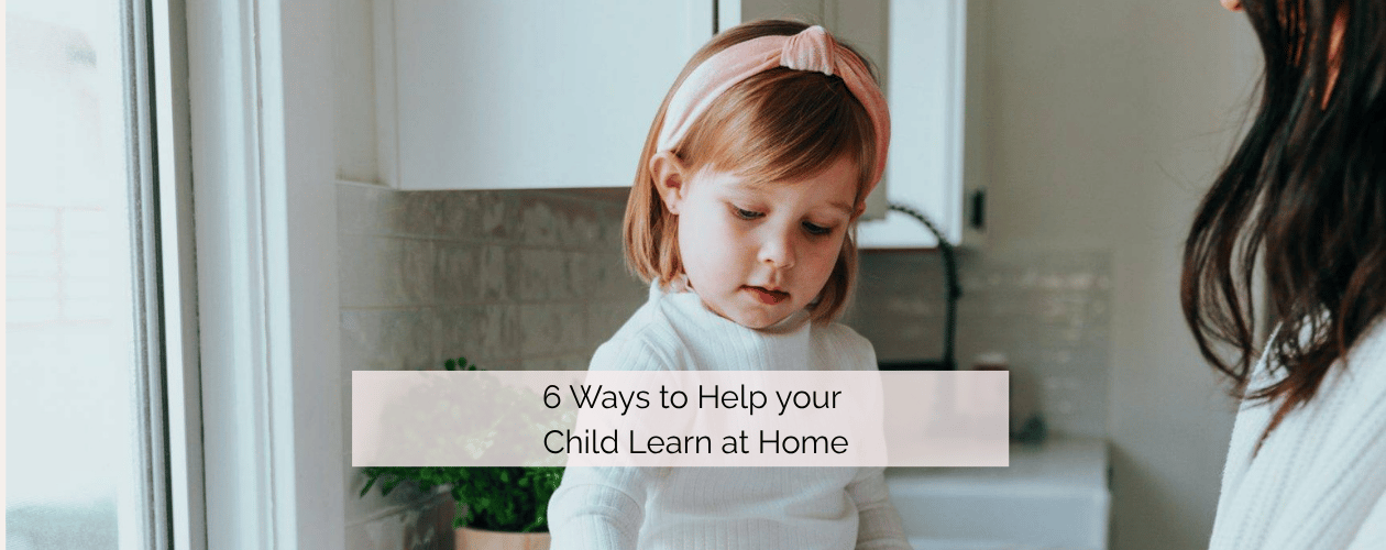 Child sitting on the kitchen counter learning with parent