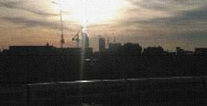 closeup of sun over buildings