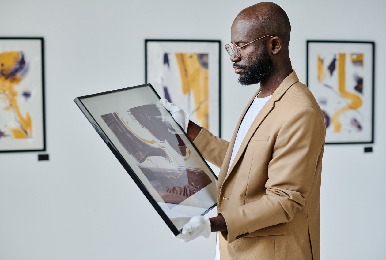An art dealer inspecting an artwork for a gallery