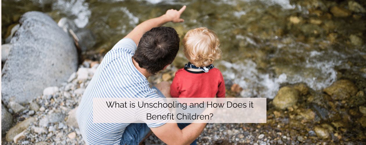 What is unschooling and how does it benefit children? - father  and child standing at the edge of a stream with father pointing something out to the child