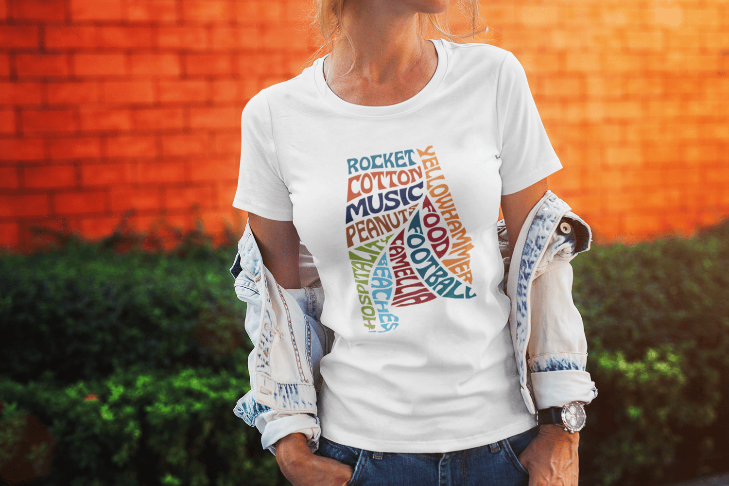 This unique design features words that represent the heart and soul of Alabama: 'Rocket,' 'Music,' 'Cotton,' 'Food,' 'Peanuts,' 'Yellowhammer,' 'Football,' 'Camellia,' 'Beaches,' and 'Hospitality,' all beautifully integrated into the silhouette of Alabama