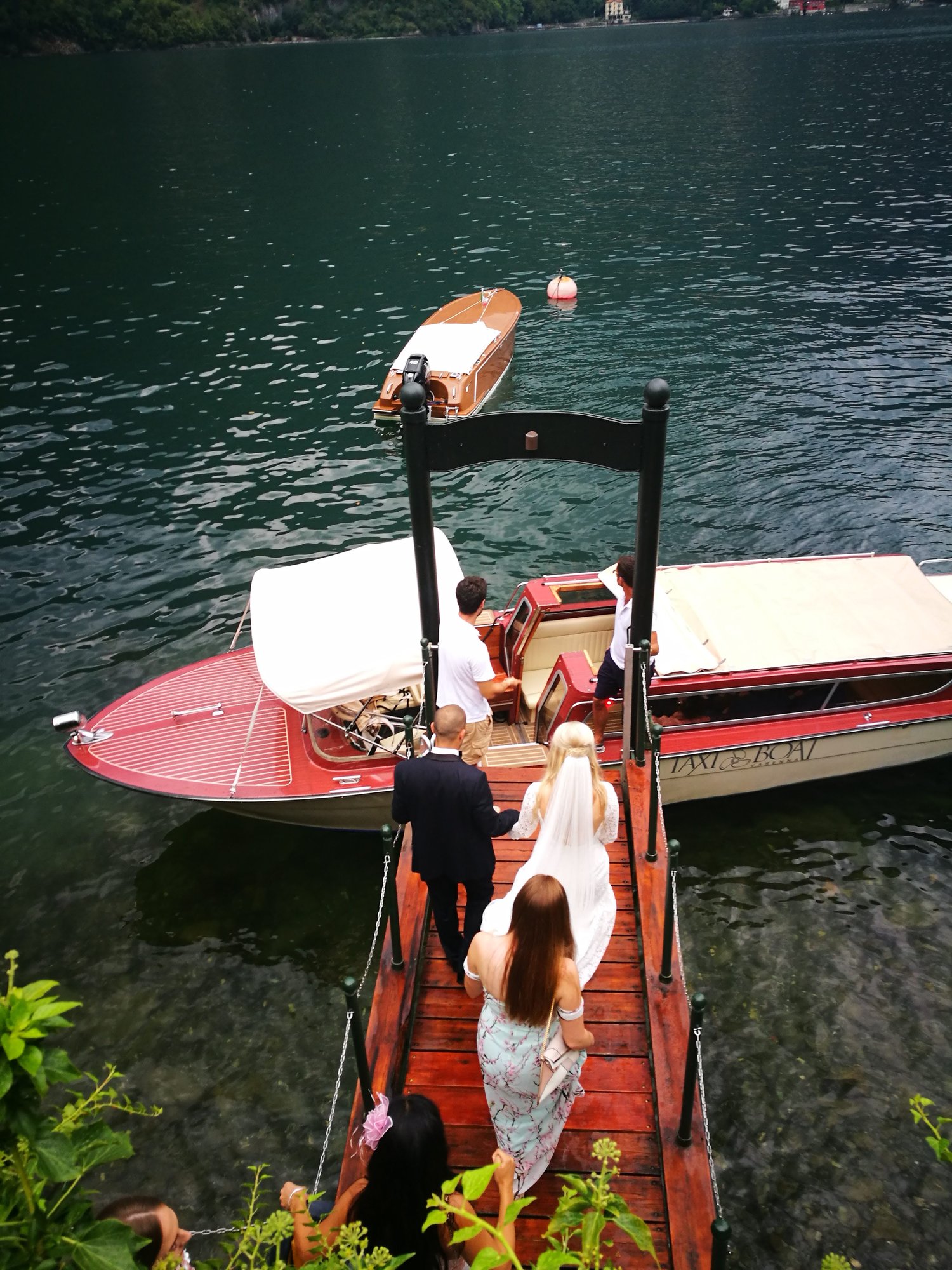 Wedding Couple boarding their private transfer boat on Lake Como
