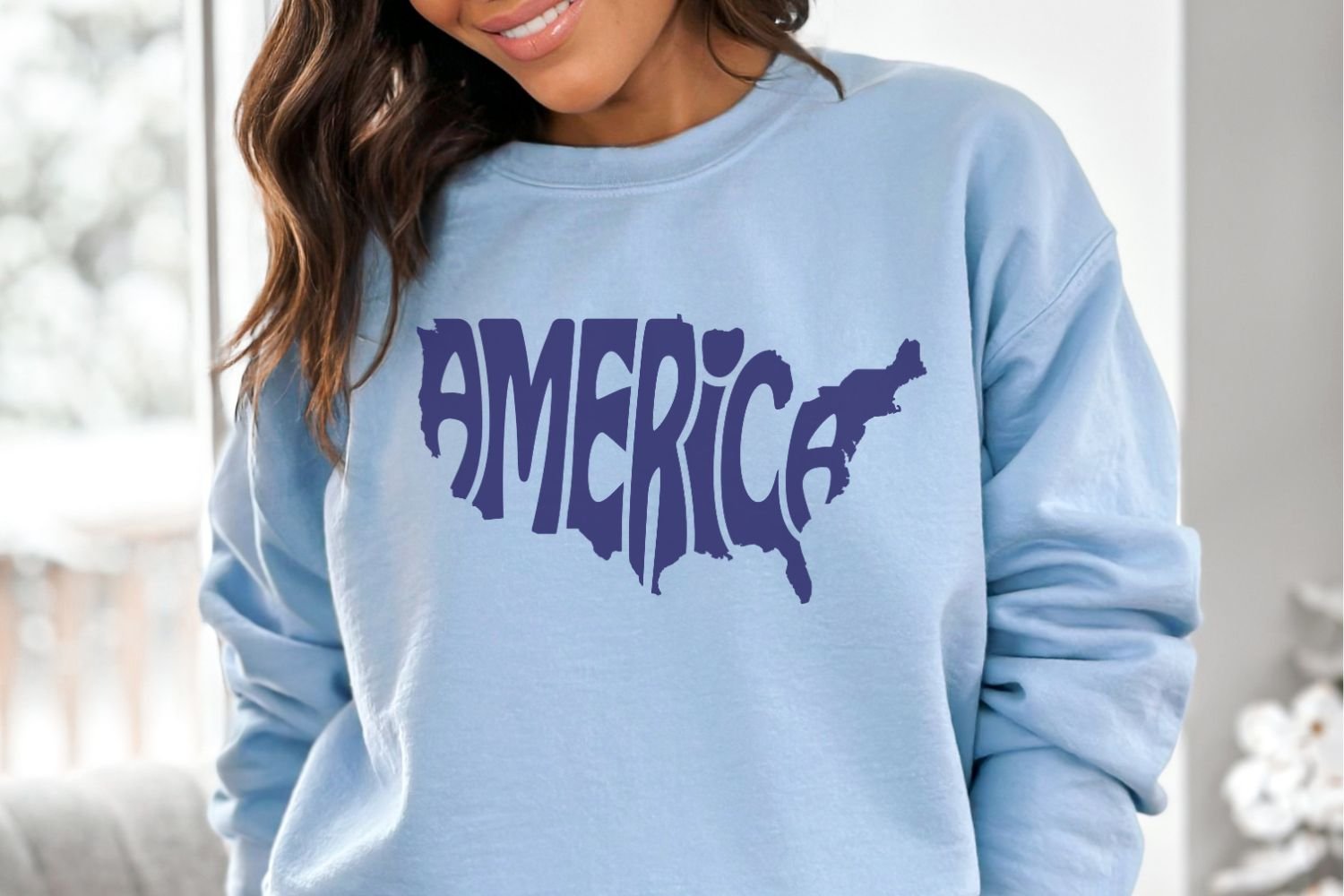 This patriotic design features the word America creatively arranged within the silhouette of the United States.