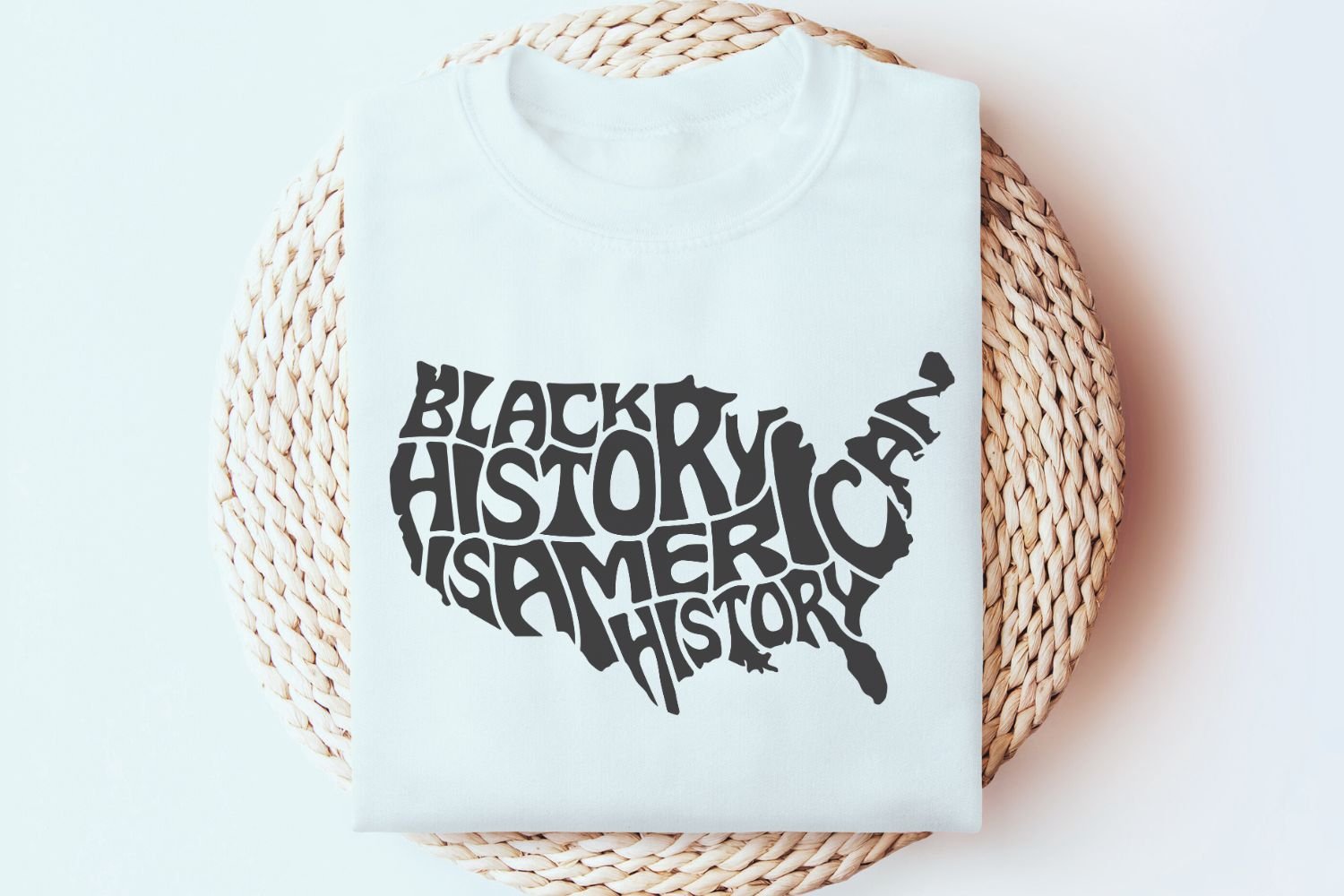 This design features the words Black History is American History creatively arranged within the silhouette of the United States.