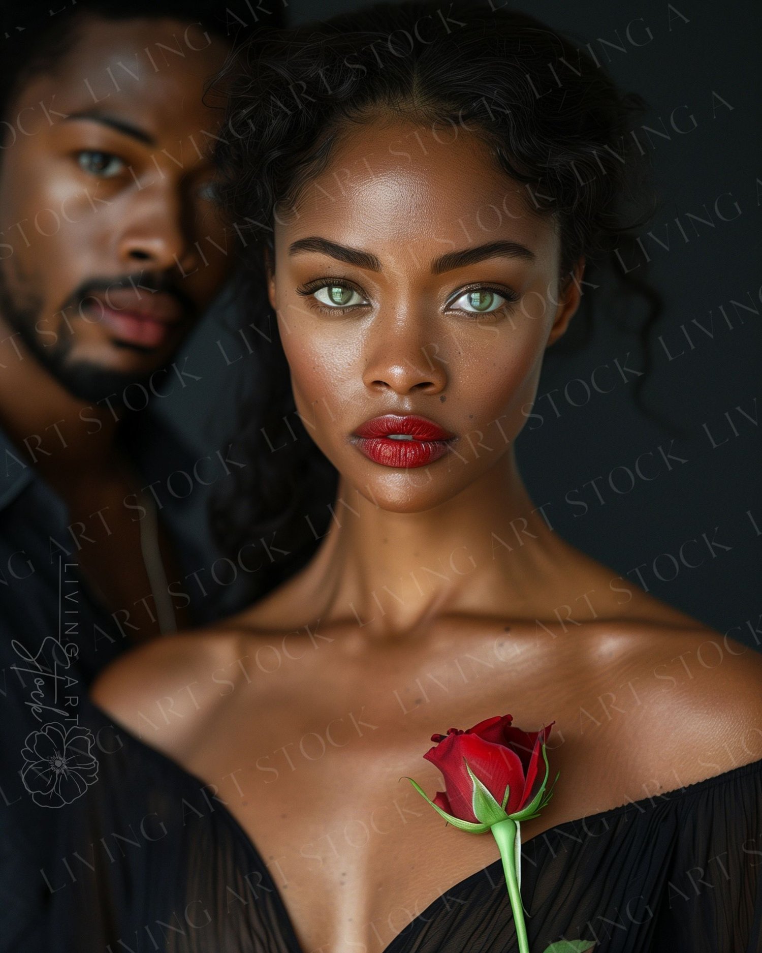 A stunning, high-contrast, editorial portrait of an attractive black couple. The focus is on the beautiful woman in the foreground, who has striking green eyes, dark curly hair, and wears a bold red lipstick and a sheer black off-the-shoulder top. She hol