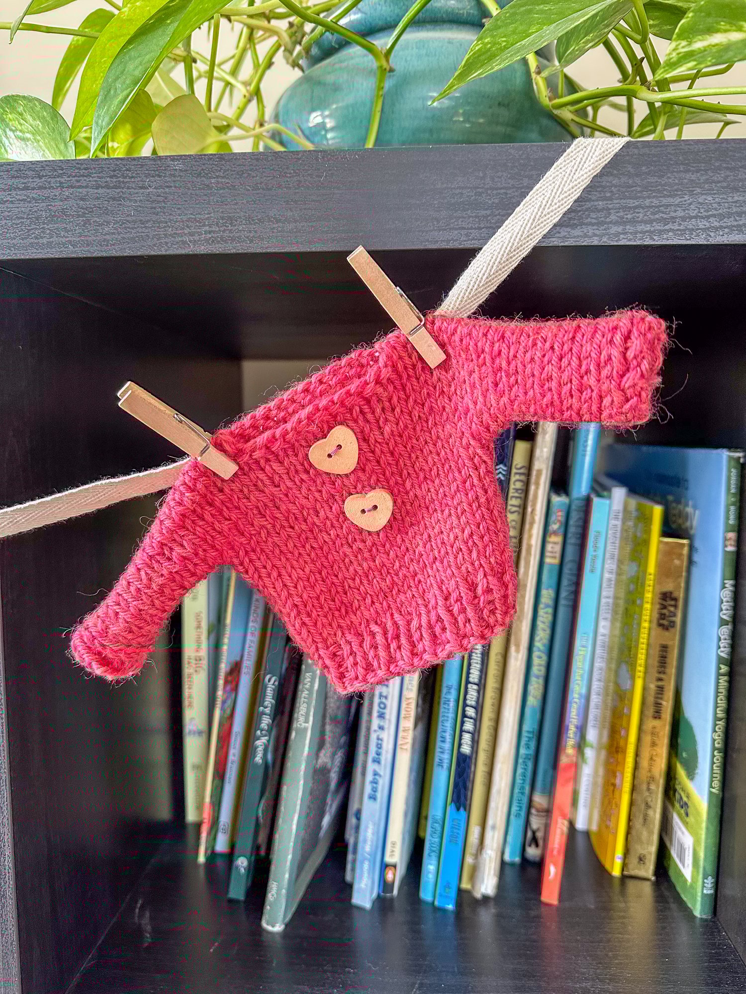 Close up of mini sweater with heart buttons