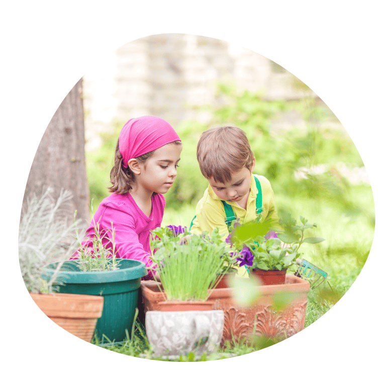 Two young Children taking care of plants in a garden