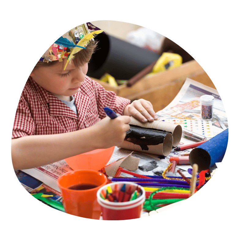 Young boy creating using recycled materials