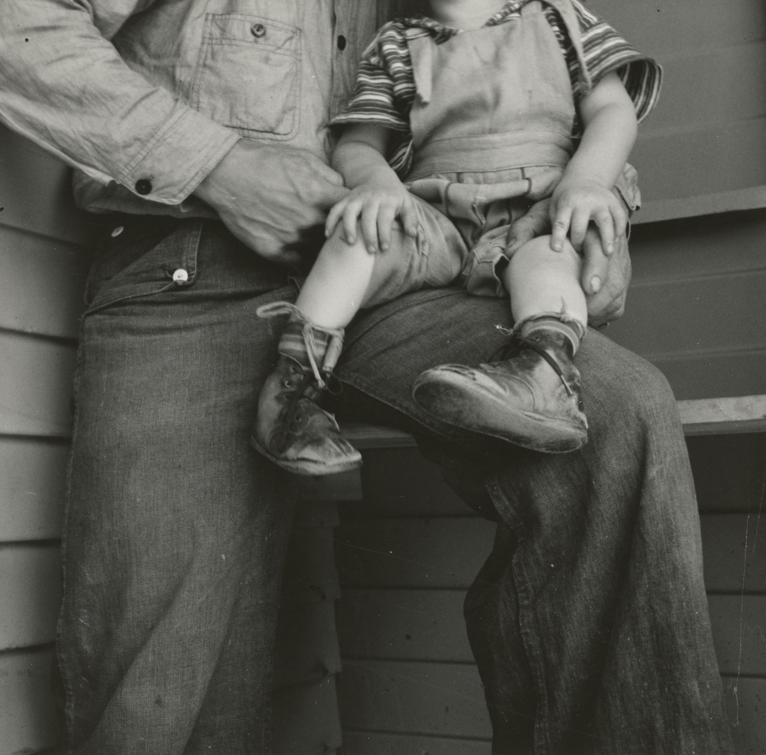 Child sitting on father’s lap