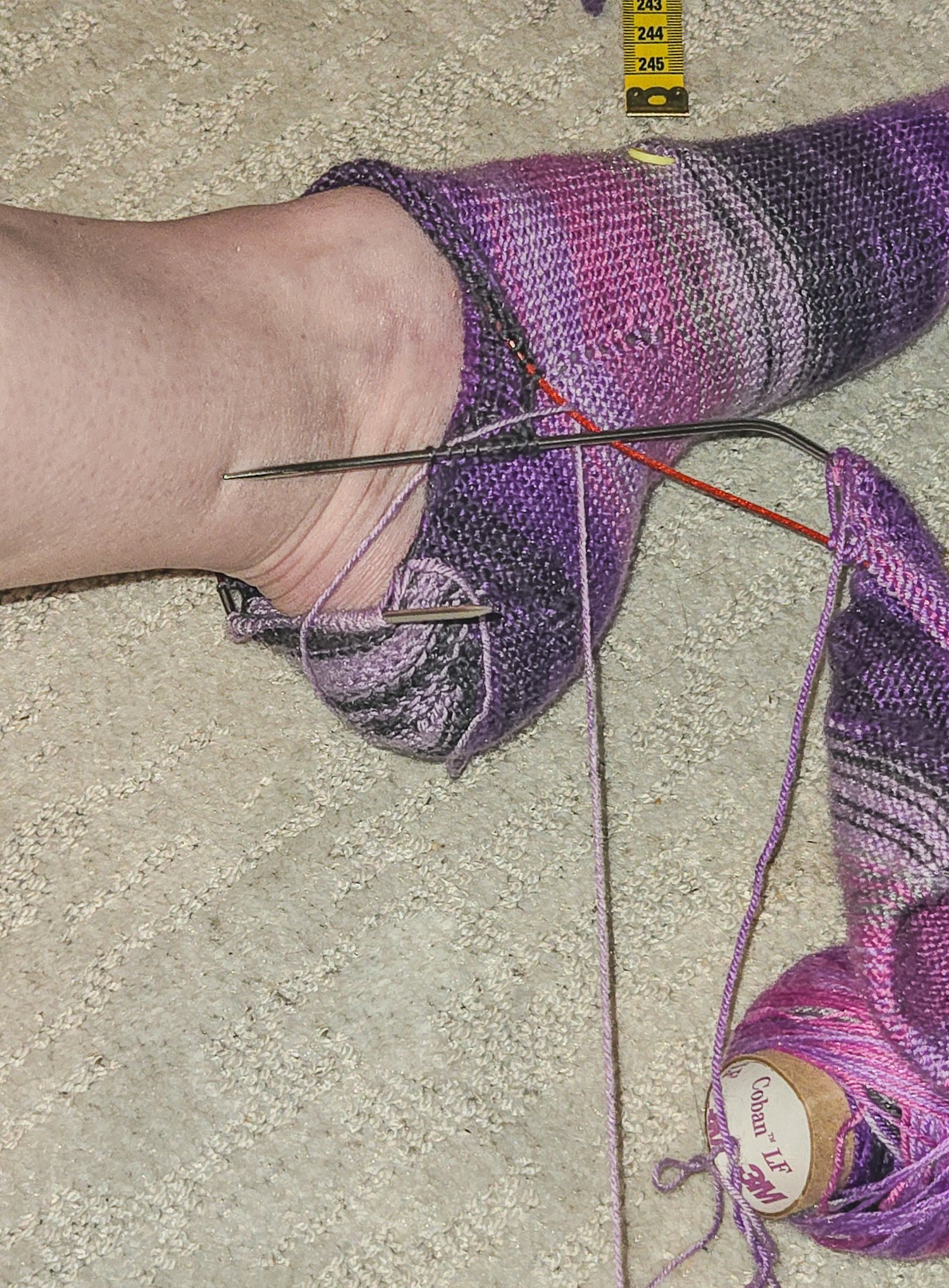 handknitted socks being tried on toe up to the heel