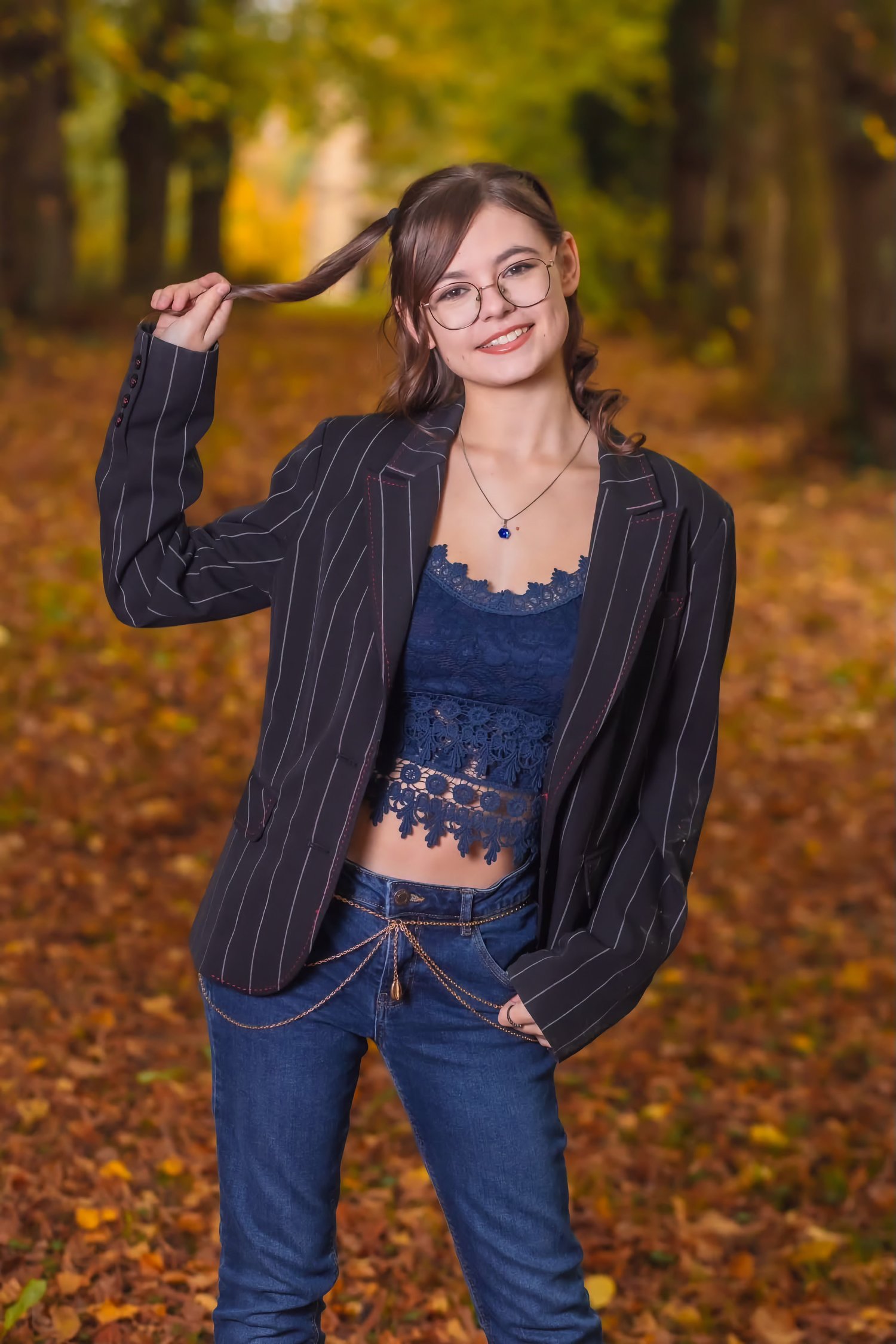 Outdoor portrait of woman in pinstripe blazer and navy lace top, smiling confidently in fall foliage – ADM Photography NJ — Autumn Portrait by Anthony DelMauro