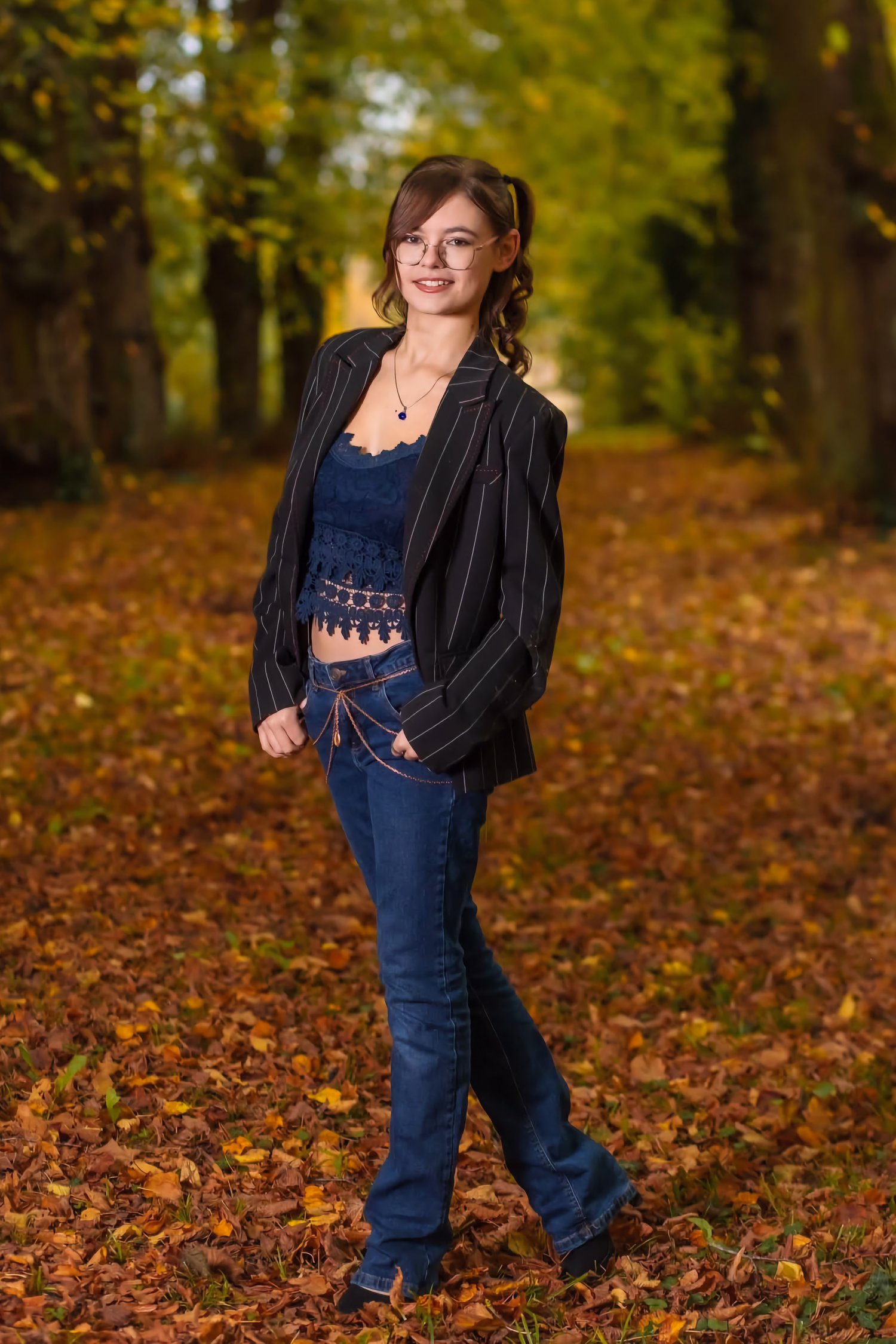 Full-body outdoor portrait of woman in striped jacket and jeans, warm autumn colors and natural light – ADM Photography New Jersey — Lifestyle Portrait by ADM Photography