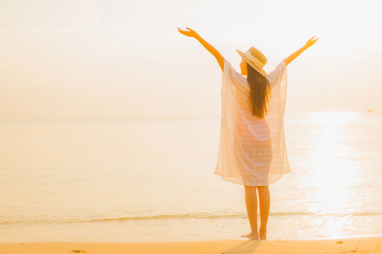 Inspired woman full of hope on sunrise beach