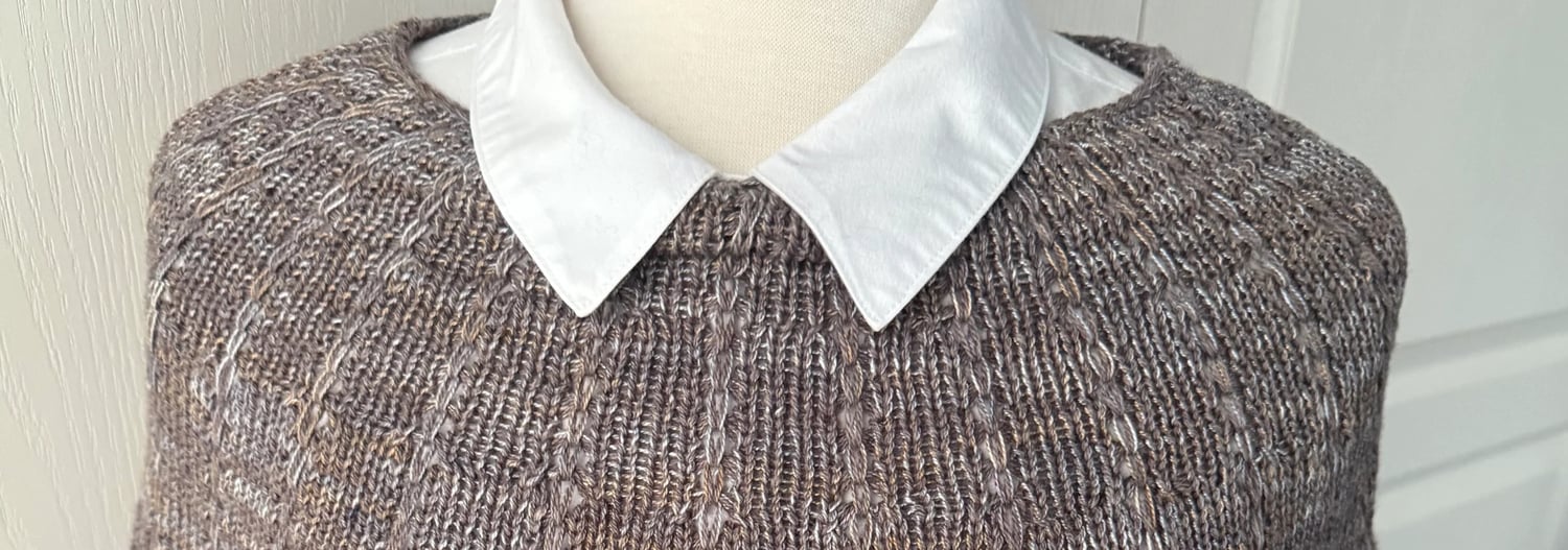 Tapered capelet with Tuck stitch pattern displayed over a white shirt