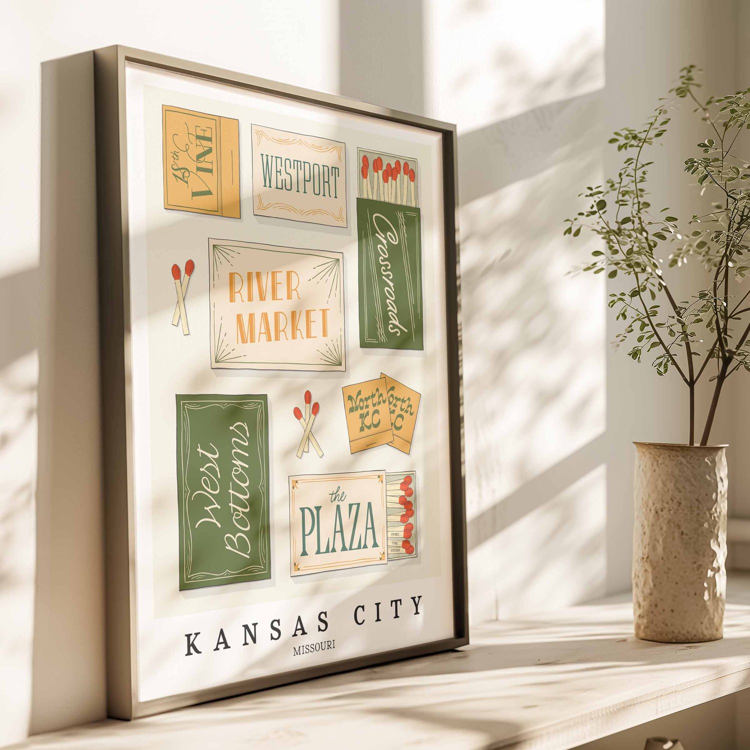 Hand-drawn Kansas City matchbox wall art featuring custom lettering in green, blue, and yellow tones