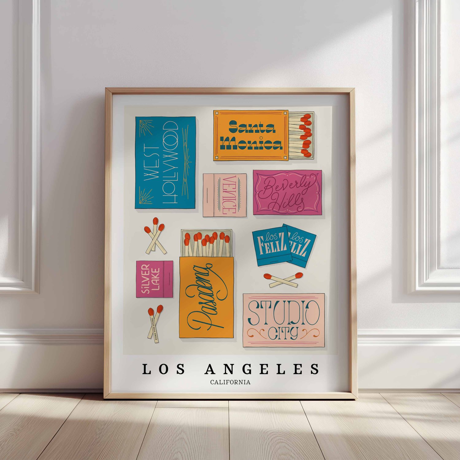 Hand-drawn Los Angeles matchbox wall art featuring custom lettering in bright blue, pink, and orange tones