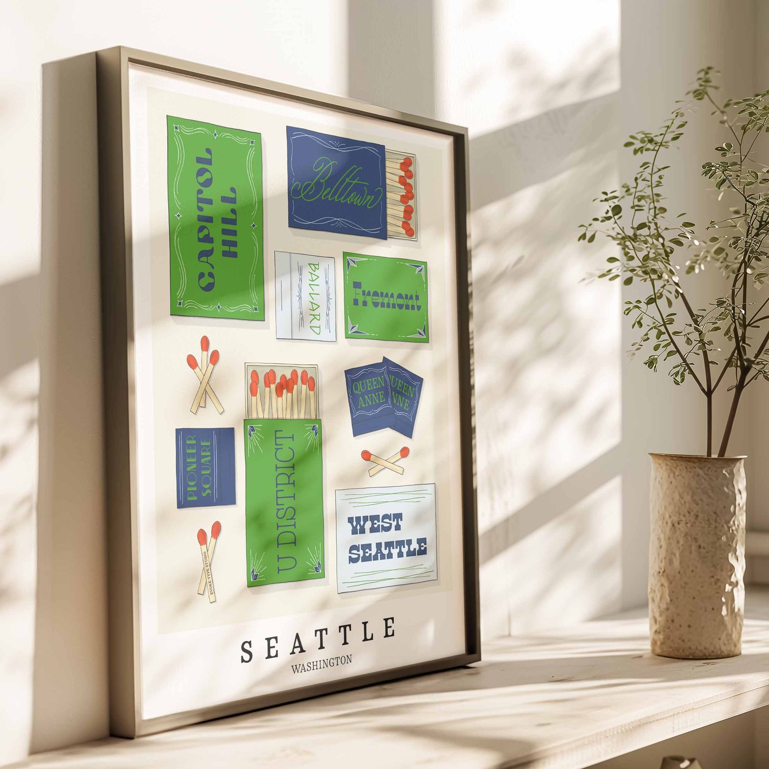 Hand-drawn Seattle matchbox wall art featuring custom lettering in bright blue and green tones