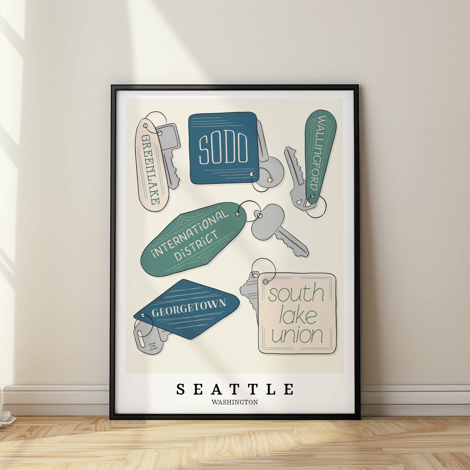 Seattle neighborhoods depicted in playful, hand-lettered key fobs with coastal-inspired colors