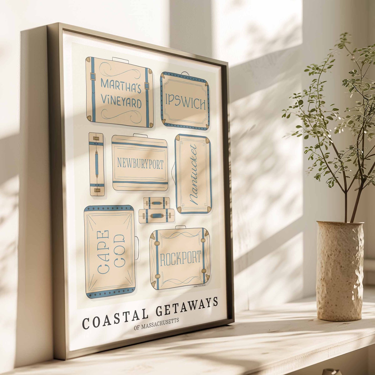 Massachusetts coastal wall art featuring illustrated suitcases in a beige and blue color scheme.