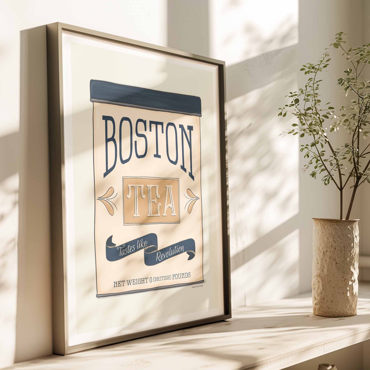 Illustrated Boston Tea Party–themed tea tin print reading ‘Tastes Like Revolution,’ styled in coastal navy and tan tones