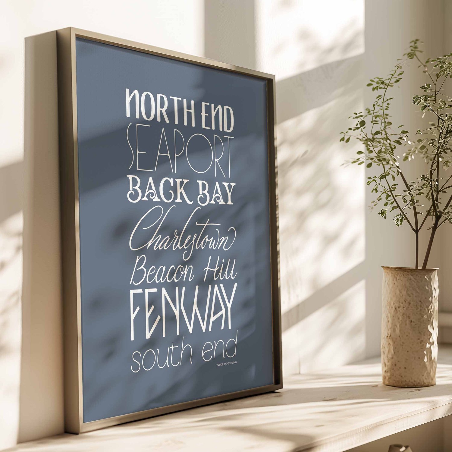 Typography-focused Boston wall art showing a stacked arrangement of seven neighborhoods in soothing blue and white tones.