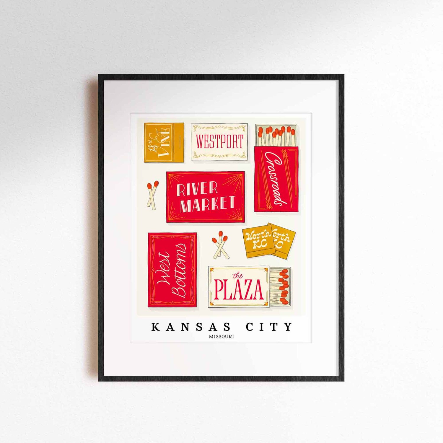 A framed picture of Kansas City, Missouri neighborhoods drawn in various lettering styles on matchboxes. Artwork has a red and gold color scheme