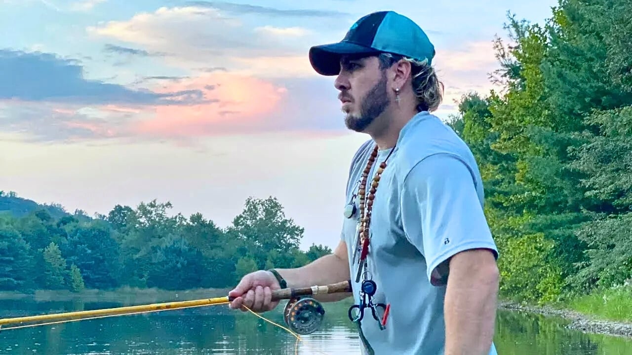 Fly fishing guide Matt Campbell retrieves a fly while fishing a small lake in Ohio.