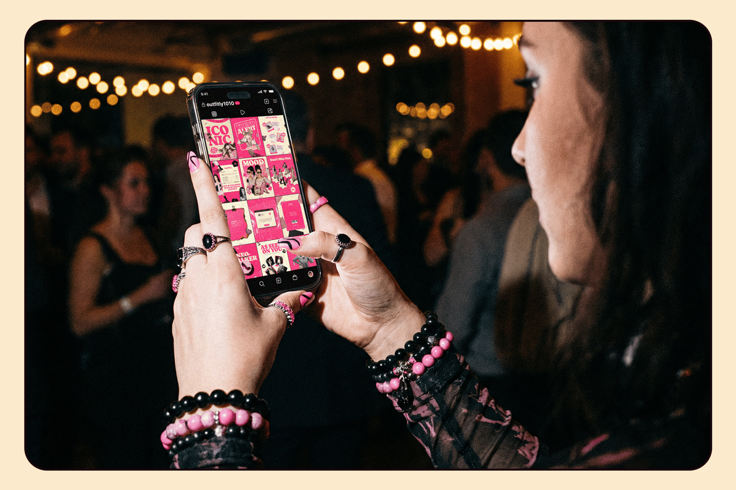 Woman holding smartphone displaying the Pink Noise Instagram feed layout in a dark party setting.