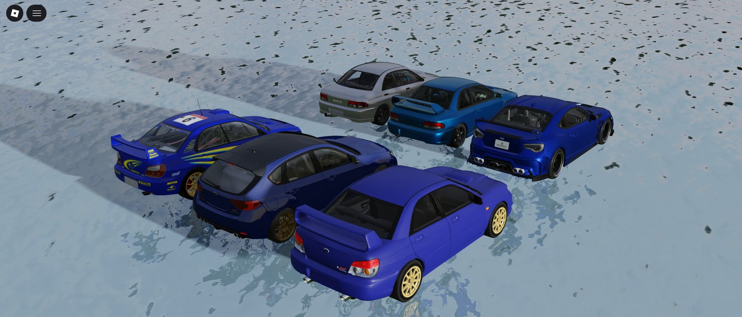 subaru race cars lined up on a racing circuit