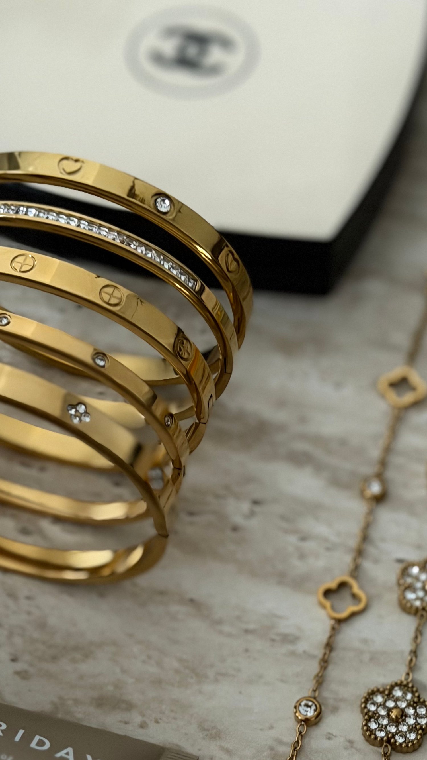 Stacked stainless steel bracelets worn on the wrist minimalist jewelry with a quiet luxury aesthetic gold by Le Maga bling