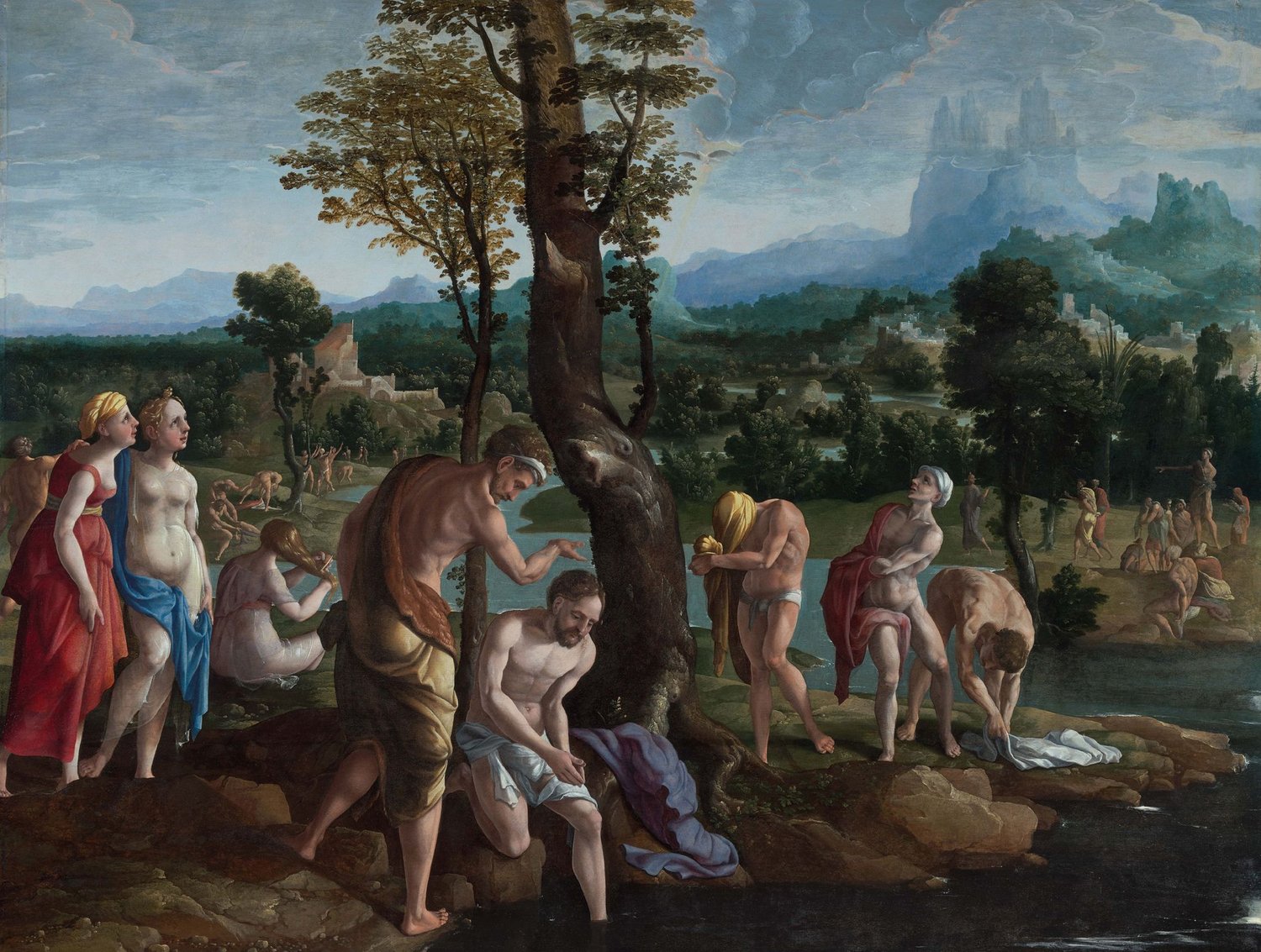 A sixteenth century painting of the Baptism of Christ. Jesus is kneeling on a rock with one foot in the water as John the Baptist pours water over him. There are lots of people in varying states of (modest) undress who have also presumably been baptised. 