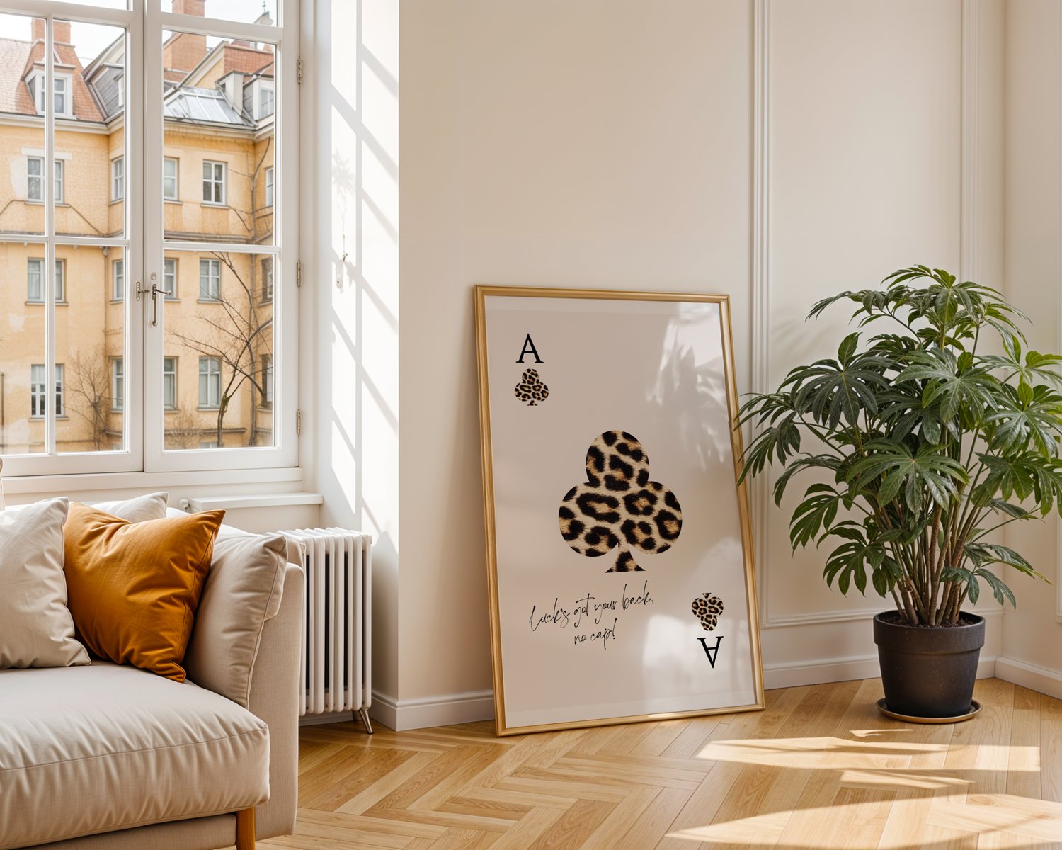 Leopard print playing card wall art poster with quote typography, framed minimalist artwork styled in a modern interior.