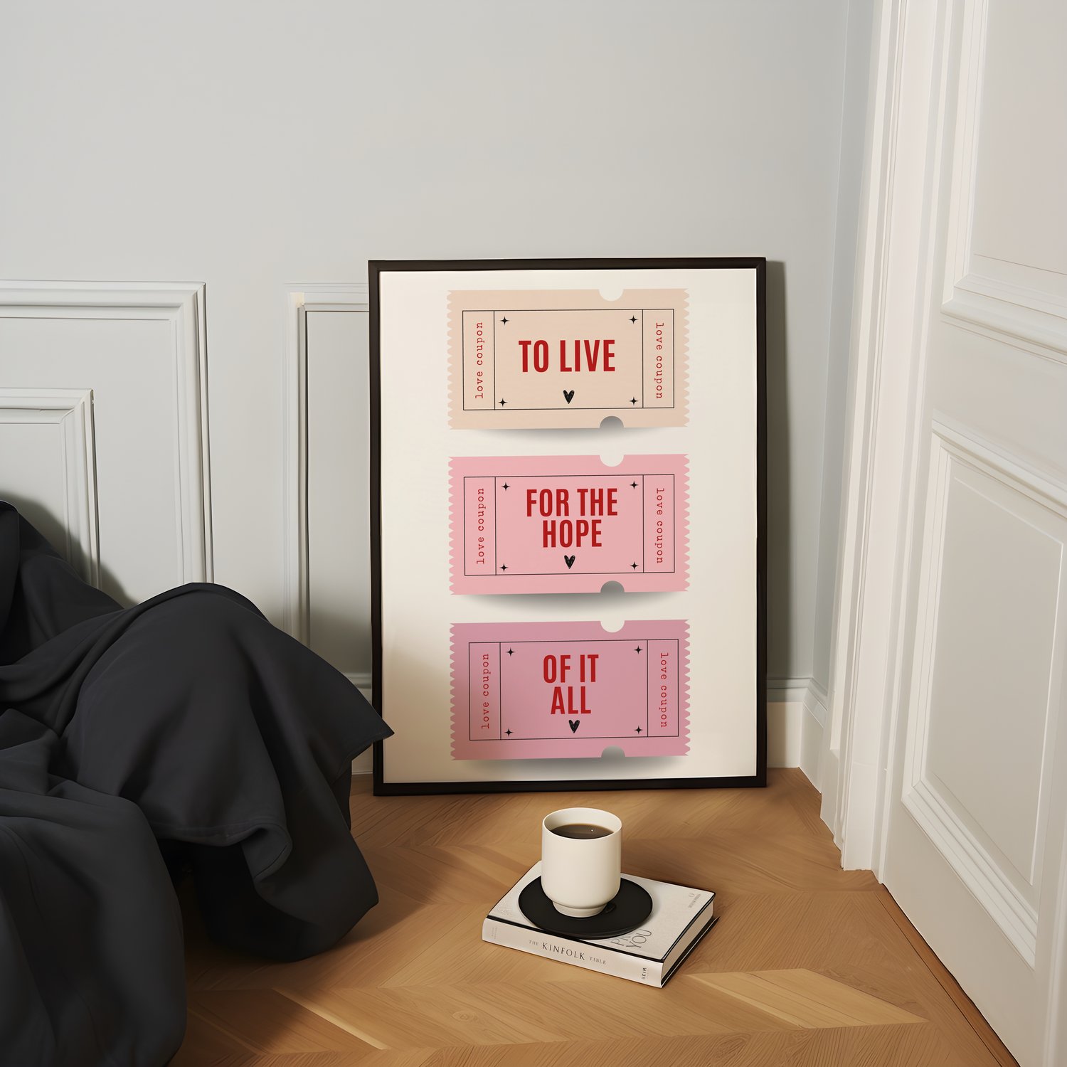 Framed quote wall art poster with stacked typography text displayed in a modern pink-toned interior.