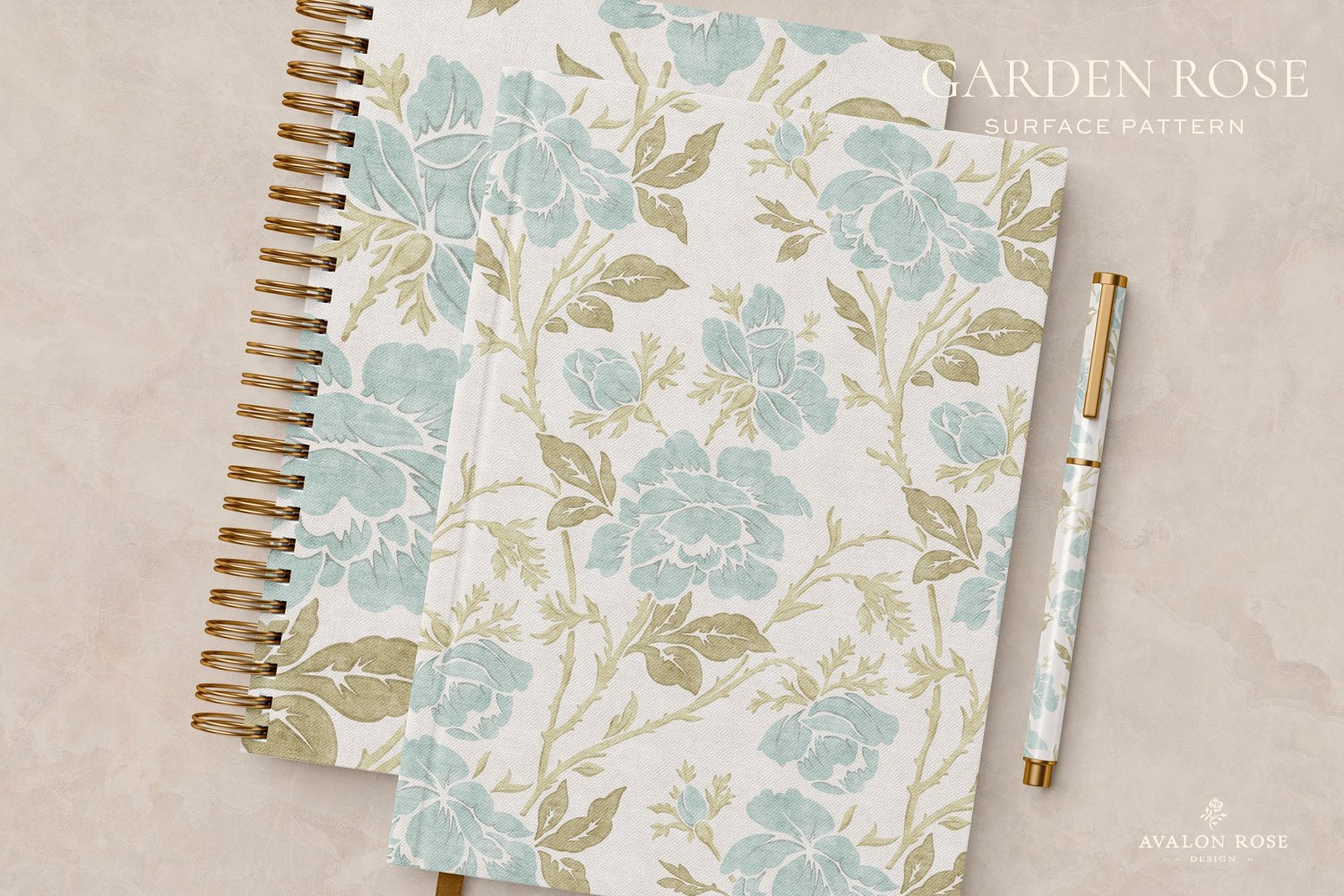 notebooks and a pen with a vintage rose illustration surface pattern in pale blue, sage green, and white