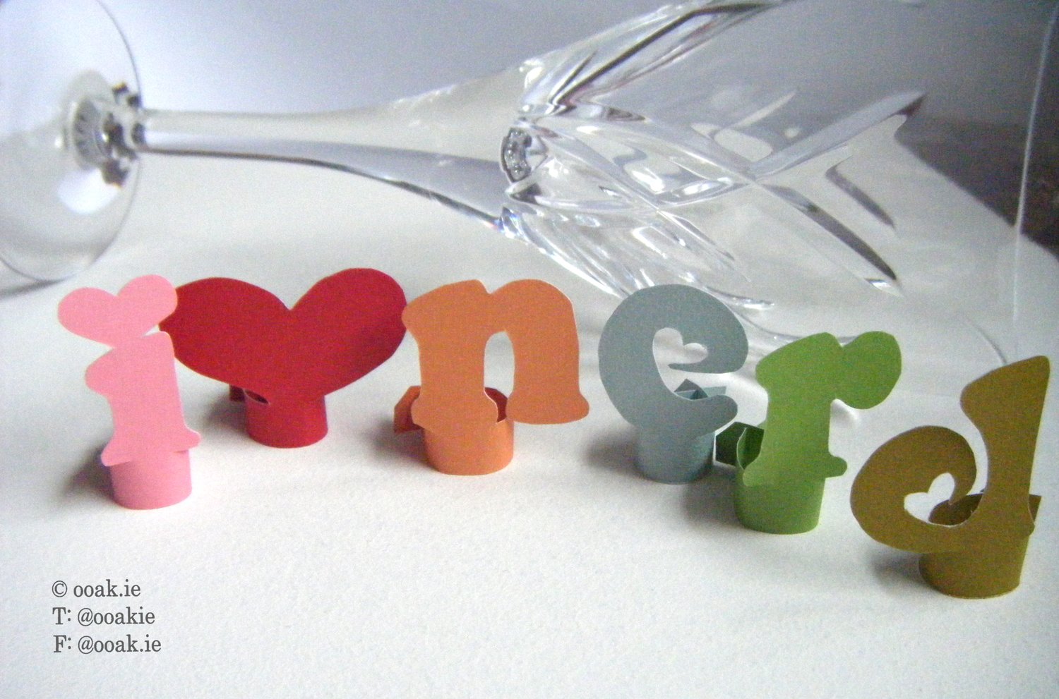 8 printable heart-themed wine glass tags spelling FRIENDS, displayed as DIY drink markers on wine glass stems.
