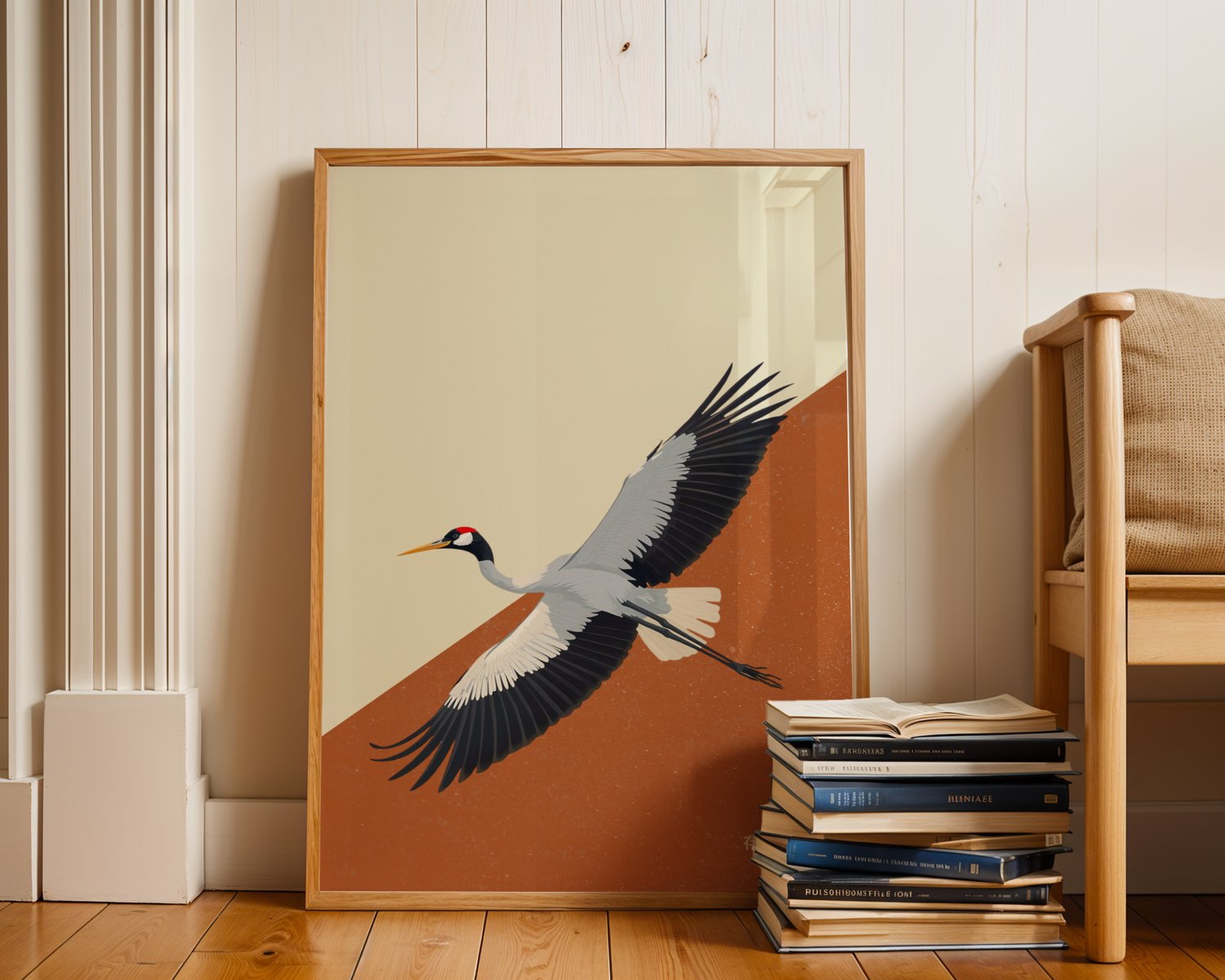 Minimalist Japanese crane wall art poster with flying crane illustration in neutral tones, framed artwork displayed in a modern interior.