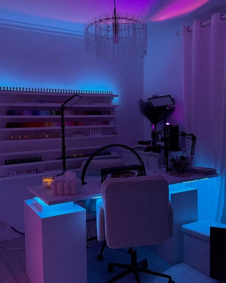 Professional nail technician applying detailed nail art on a client’s hands in a modern, well-lit nail studio, demonstrating skill and precision.