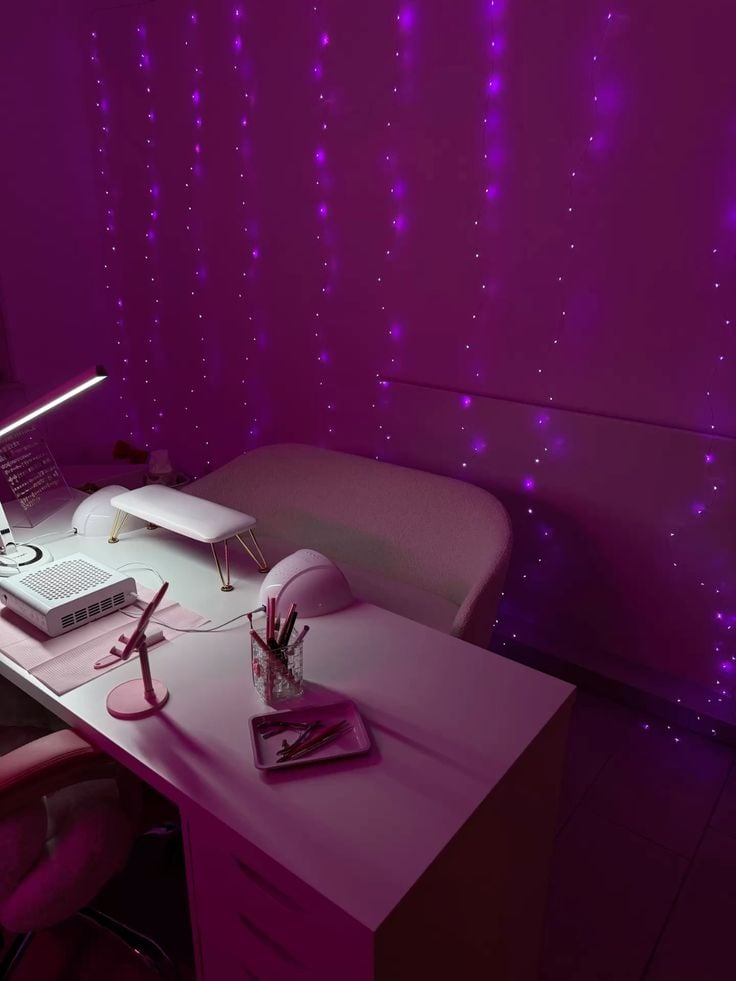A nail technician applying detailed nail art to a client’s nails in a bright, modern nail studio with organized tools.