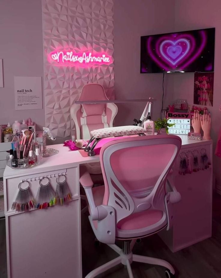 A nail technician carefully painting detailed nail art on a client’s nails in a bright, modern, organized studio.