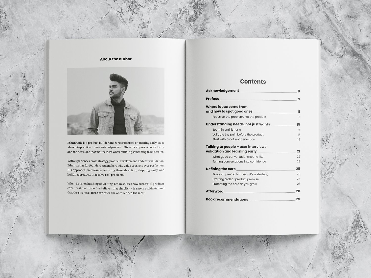 Open book with a black-and-white photograph of a man on the left page and a table of contents on the right page. The book lies on a marble surface. The text includes “About the Author” and “Table of Contents.”