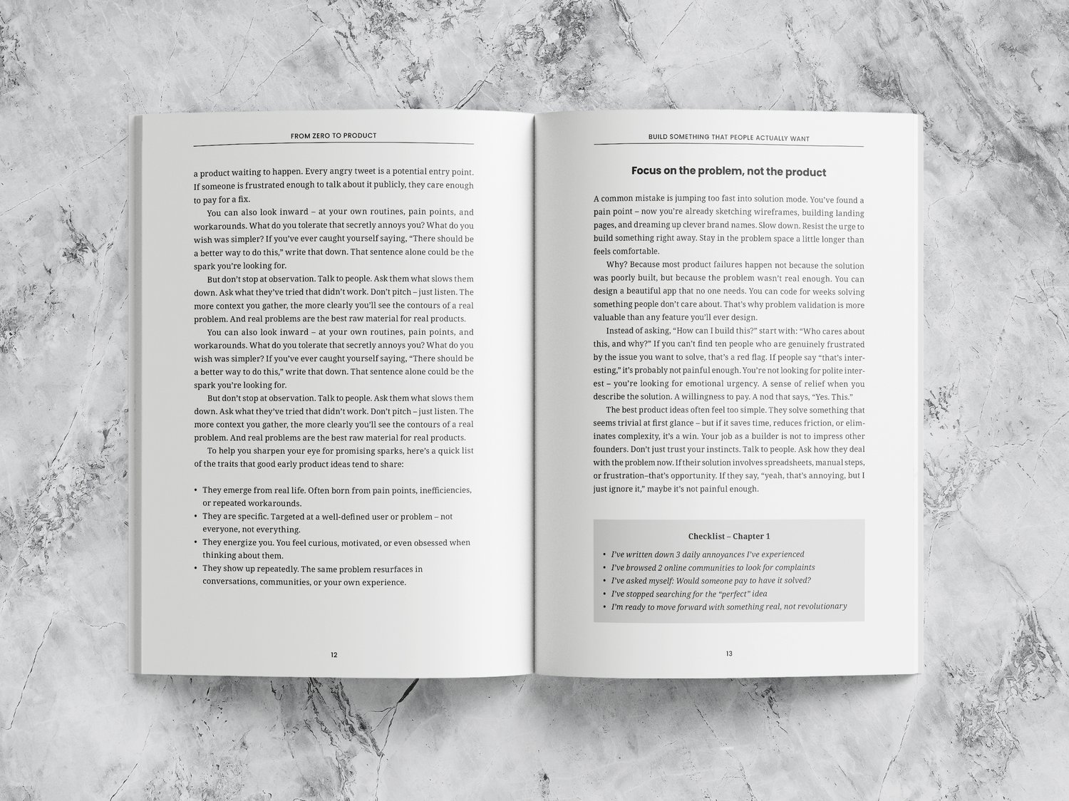 Mockup of an open book featuring various text styles and a gray highlighted checkbox. The book lies on a marble surface.