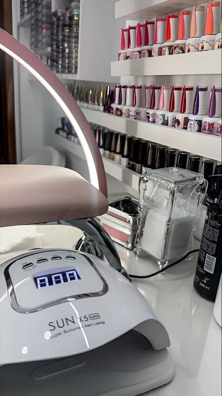 Nail technician practicing intricate nail art on a client’s hands in a clean, modern studio, demonstrating consistency and professional skill.