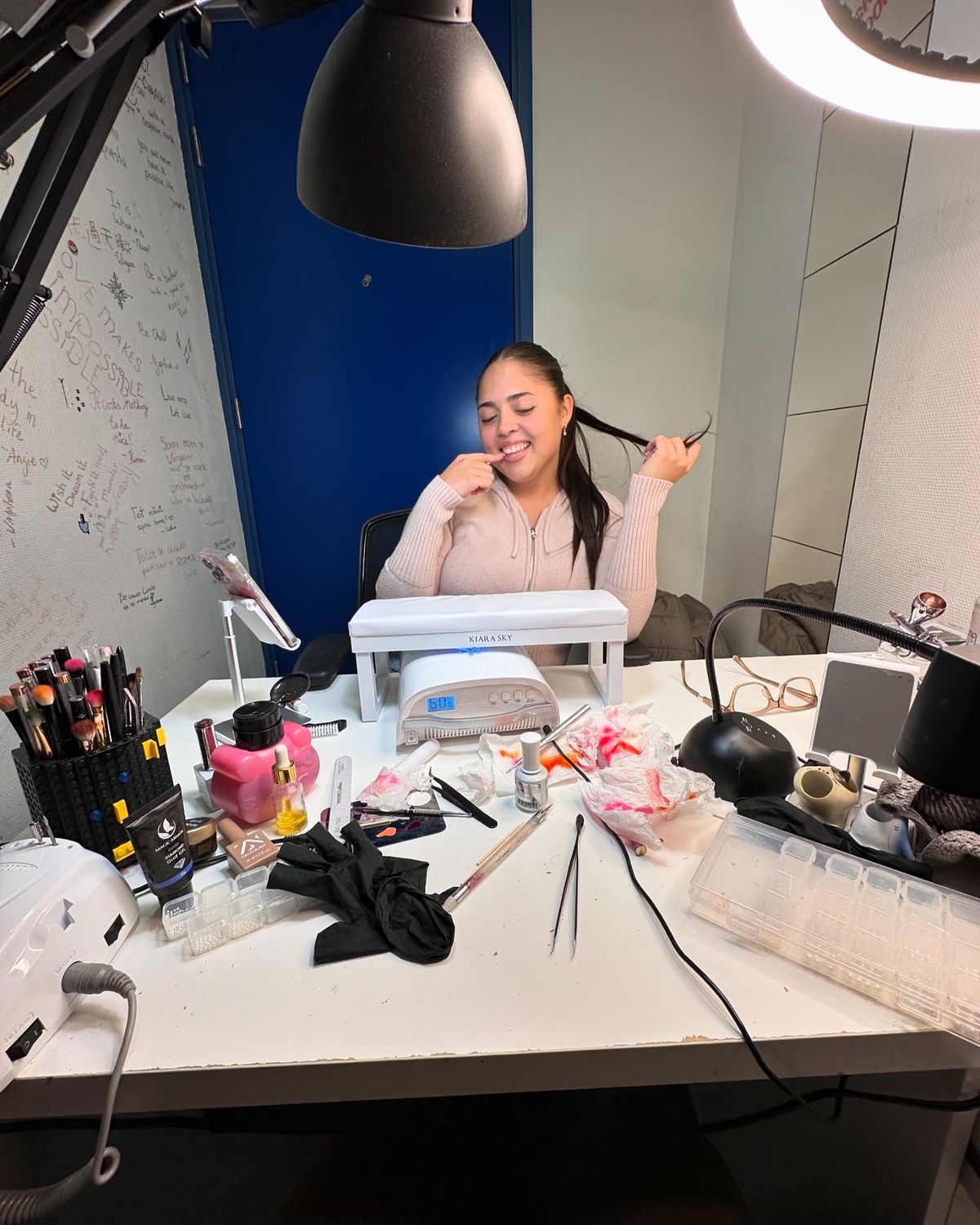 Nail technician performing a luxury manicure on a client in an elegant studio, demonstrating professional skills and premium service.