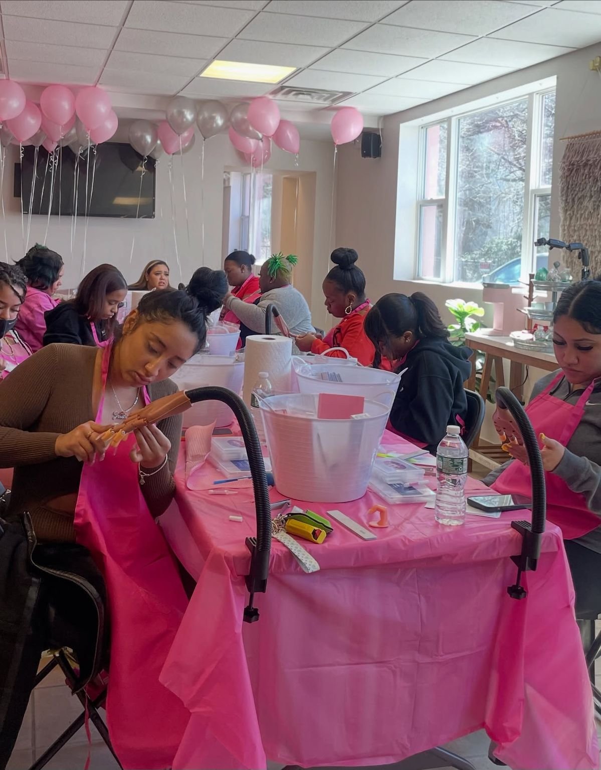Nail technician planning finances and scheduling in a clean, modern nail studio, demonstrating strategic business planning for increased income.