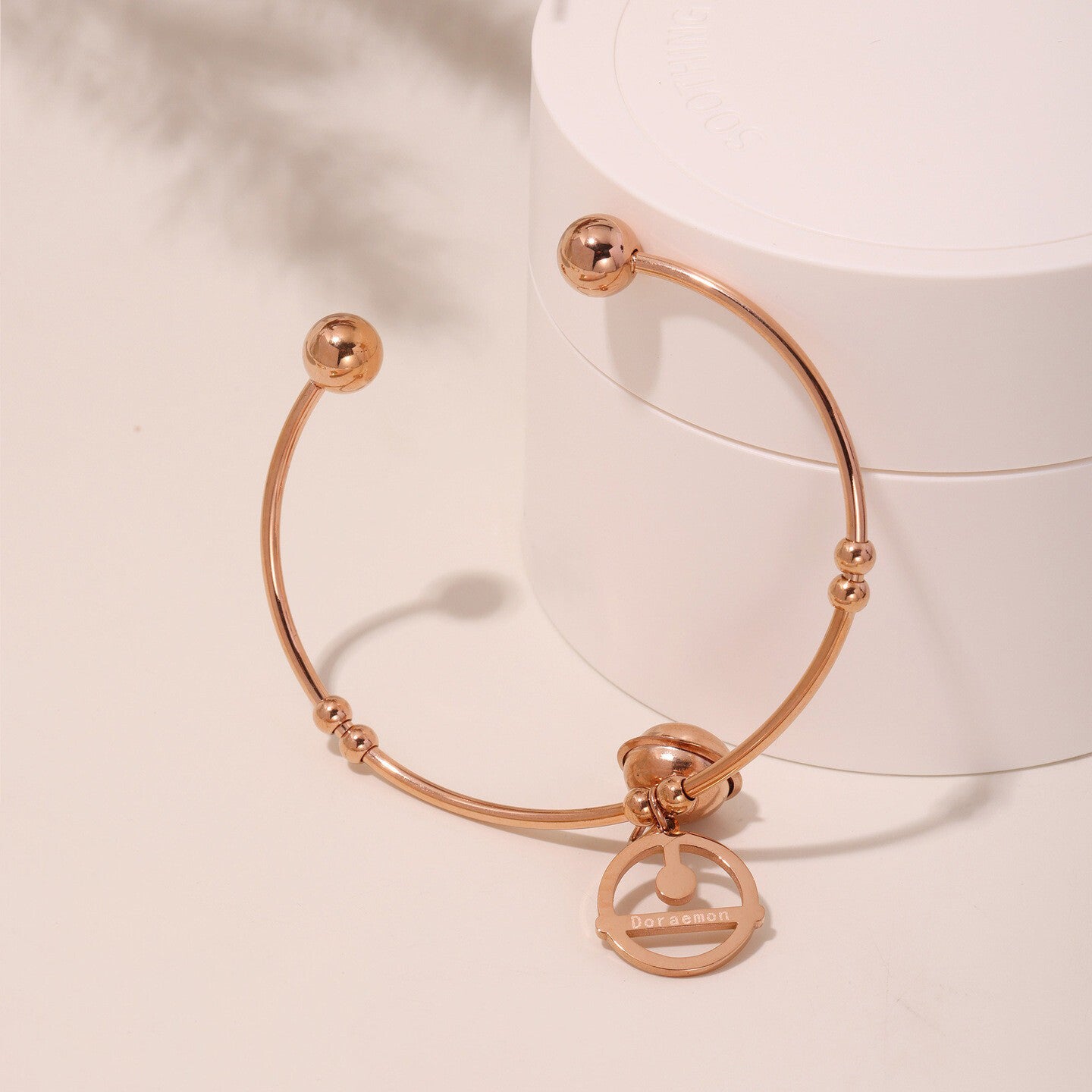 Adjustable titanium steel bracelet with 18K gold bell charms