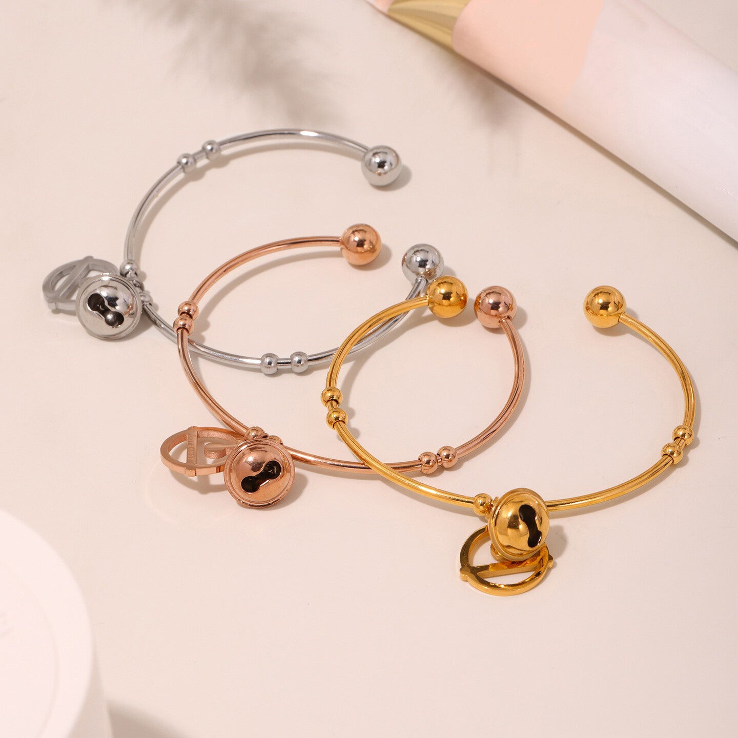 Adjustable women’s bracelet with dual bell charm design