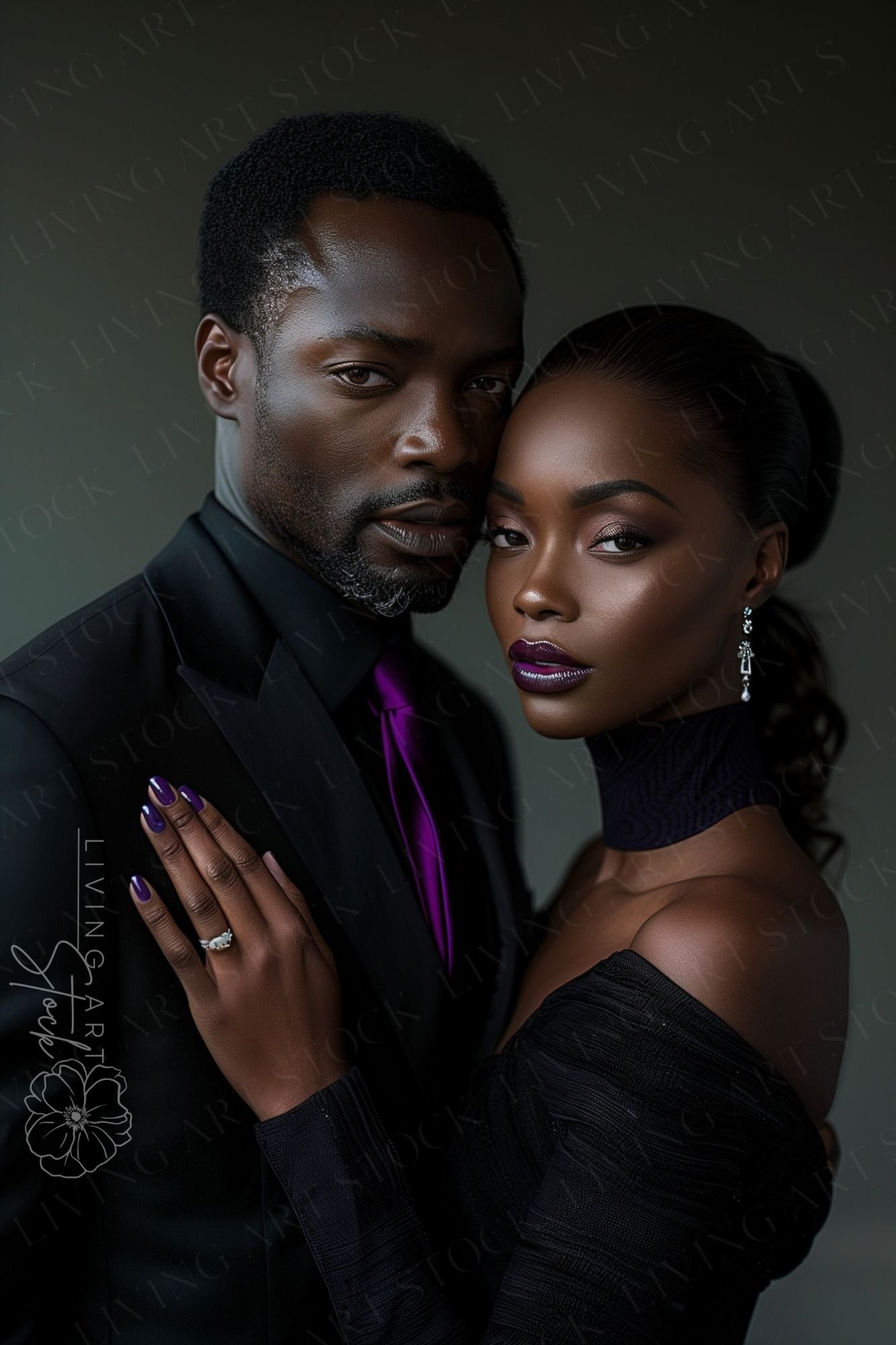 An intimate, high-contrast portrait of an elegant Black couple in formal wear. The woman, wearing a sleek ponytail and a textured black off-the-shoulder dress with a high collar, rests her hand on the man's chest, prominently displaying a large diamond en